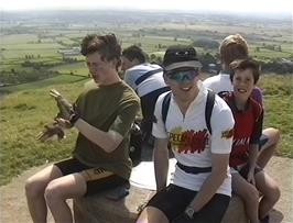 The group surveys the extensive views from the top of Glastonbury Tor